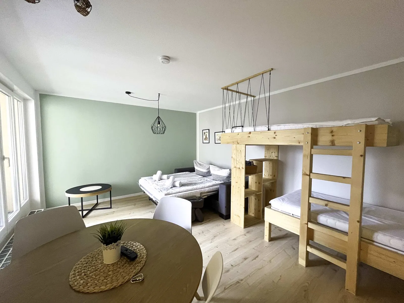 Living room with loft bed and dining table