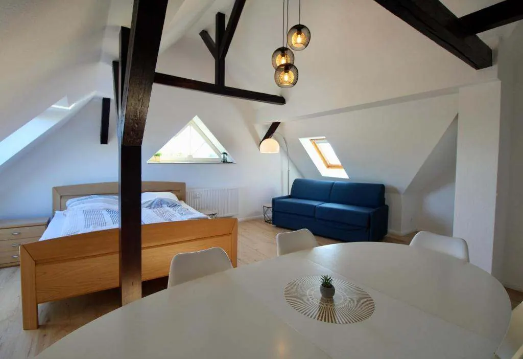 Living room with dining table under the roof beams